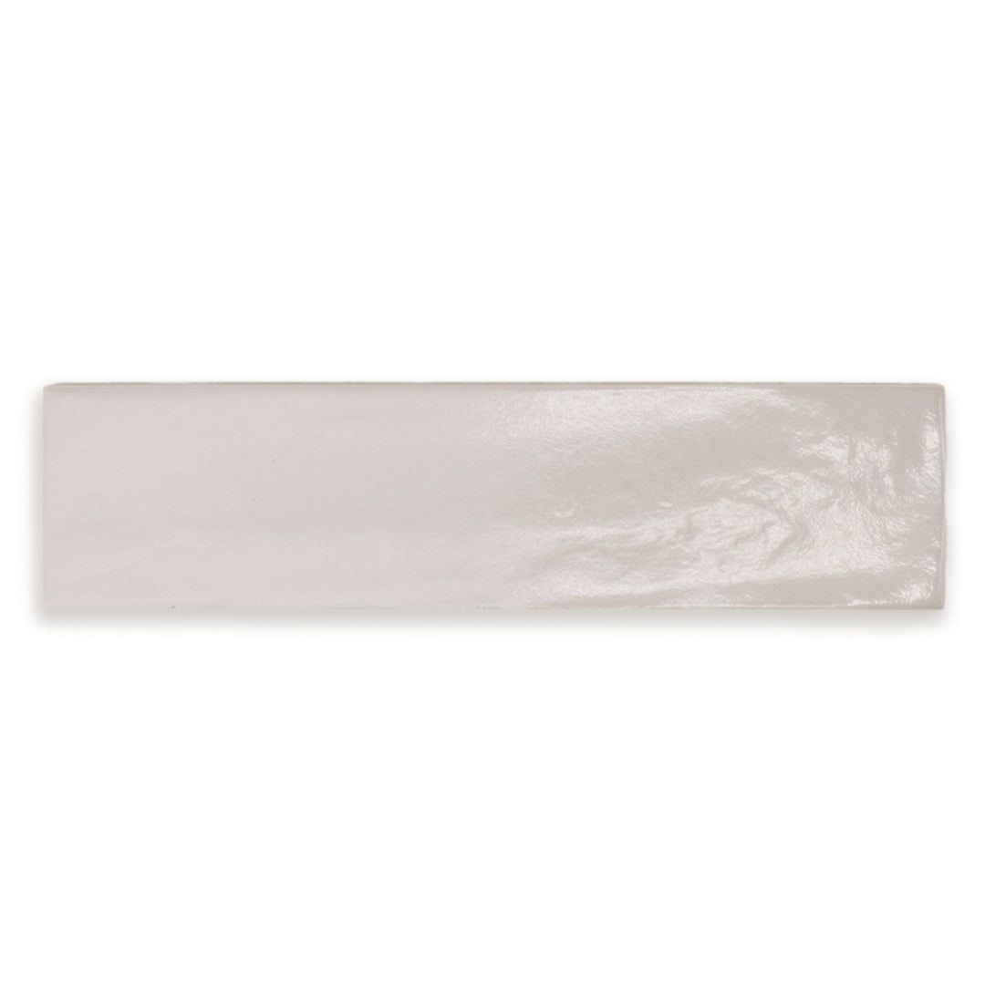 A single 3x12 light grey textured glossy tile. 