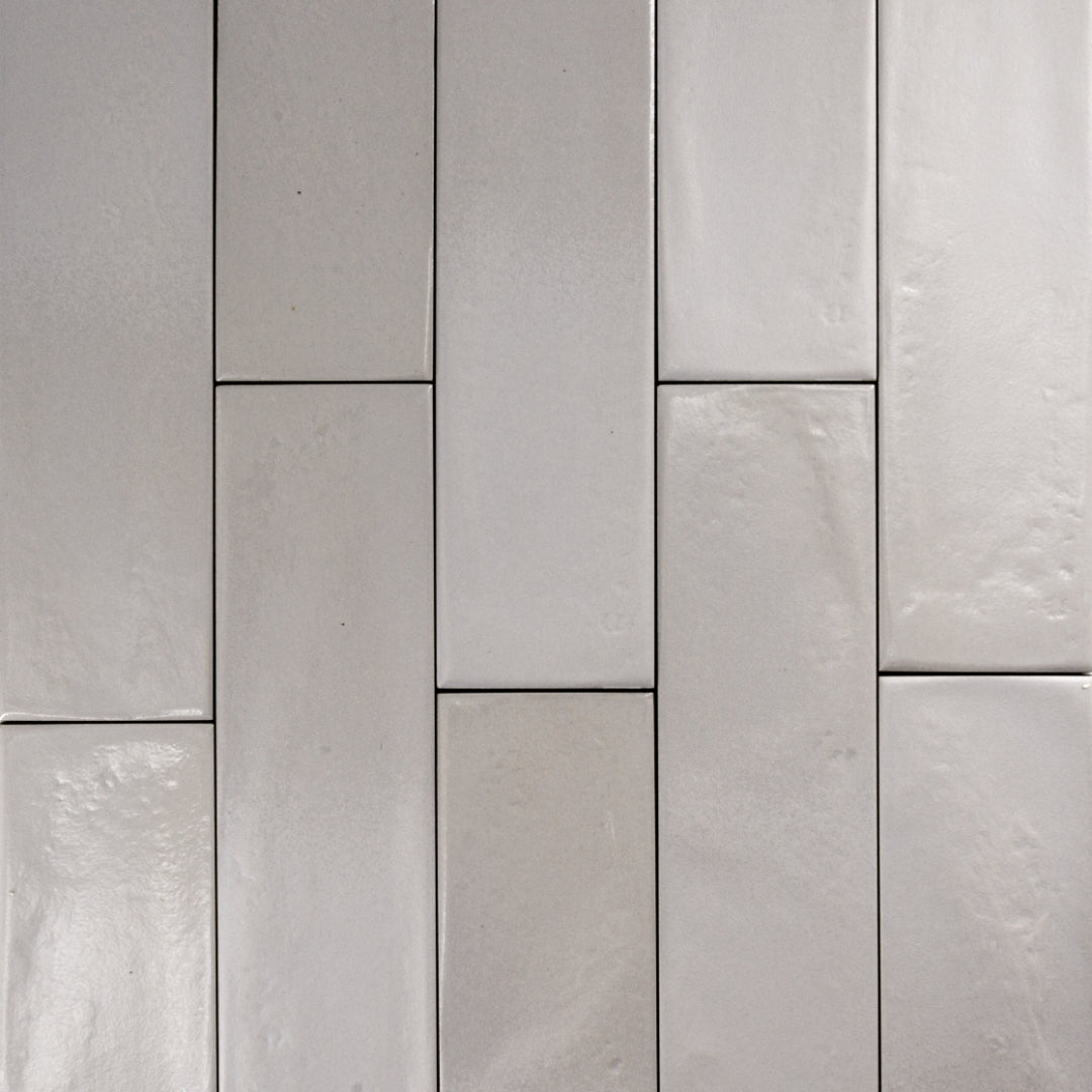 Ariel view of 3x12 glossy textured light grey tiles in a brick layout. 
