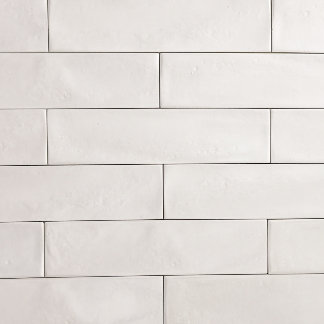 Ariel view of 3x12 glossy textured white tiles in a brick layout. 