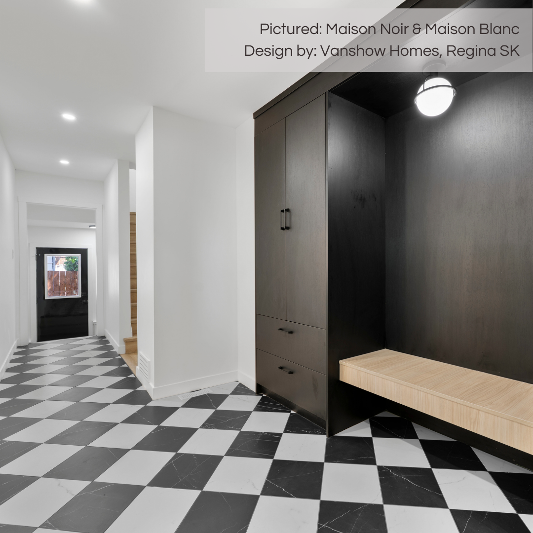 An luxury front entrance complete with an expansive mudroom section. The front door and cabinets are black and the walls are white. The floors are tiled in a diamond checkerboard harlequin design, the tiles are maison blanc white and maison noir black marble look porcelain 12x12.  