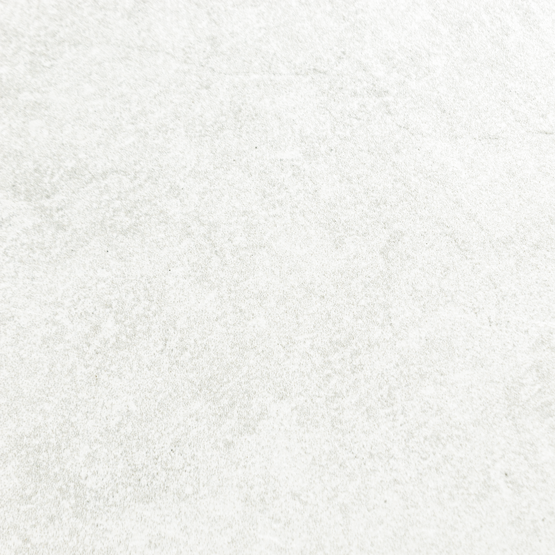 A close up of white stone look tiles with veining and a colour variated pattern.