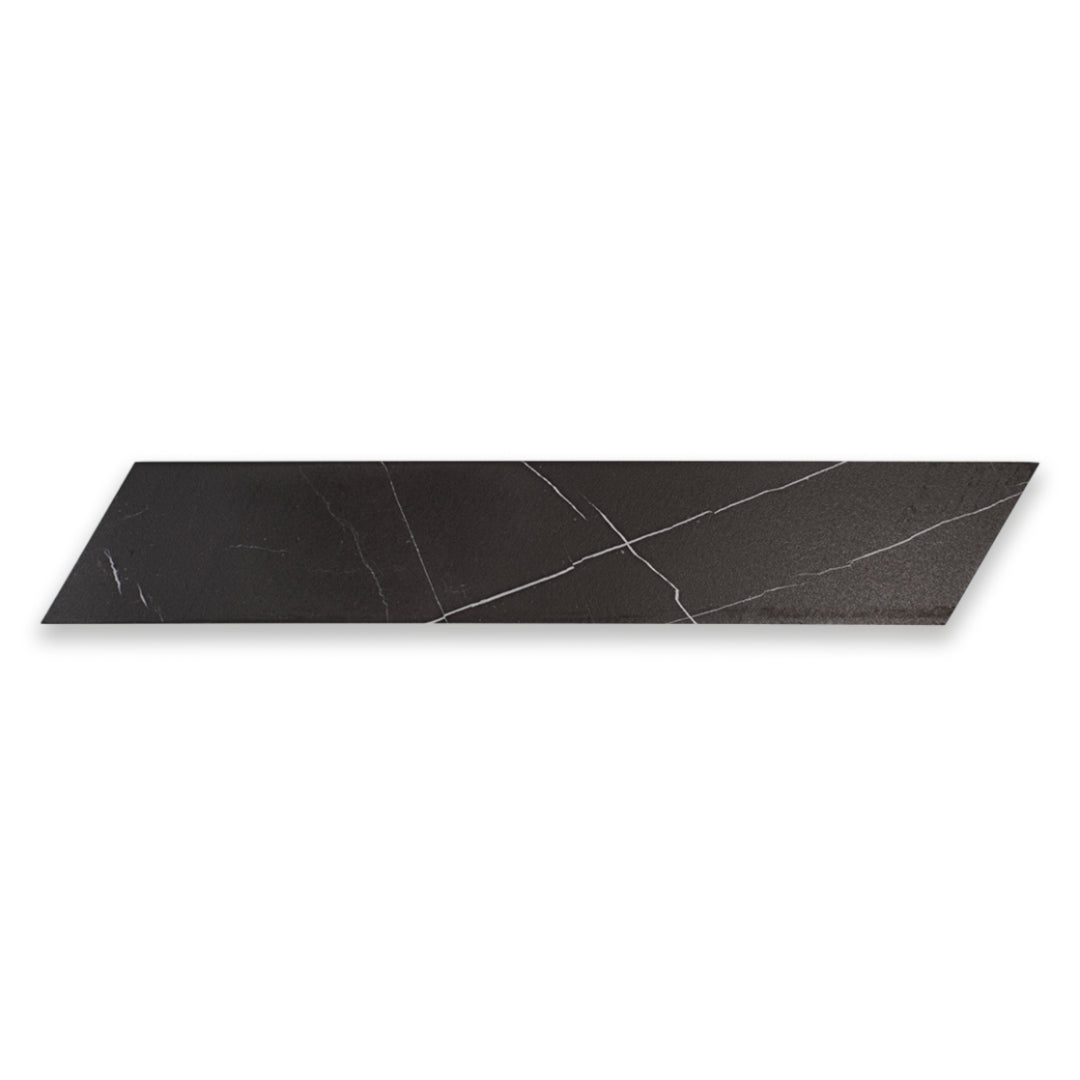 Ariel view of a single 4x20 chevron tile in matte black marble look porcelain with white veining. 