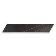 Ariel view of a single 4x20 chevron tile in matte black marble look porcelain with white veining. 
