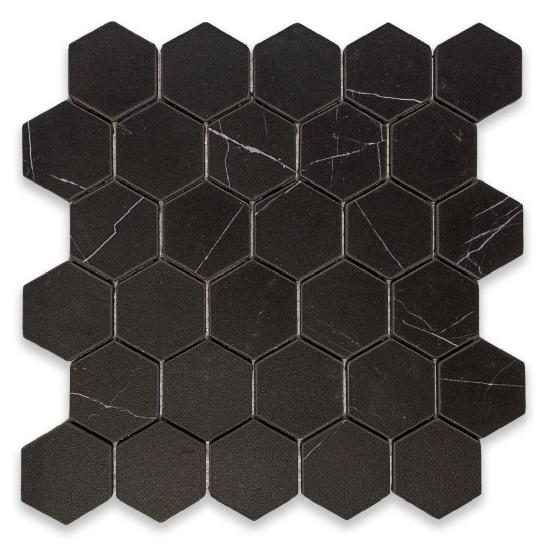 Ariel view of a matte black marble look porcelain hexagon mosaic tile sheet. 