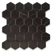 Ariel view of a matte black marble look porcelain hexagon mosaic tile sheet. 