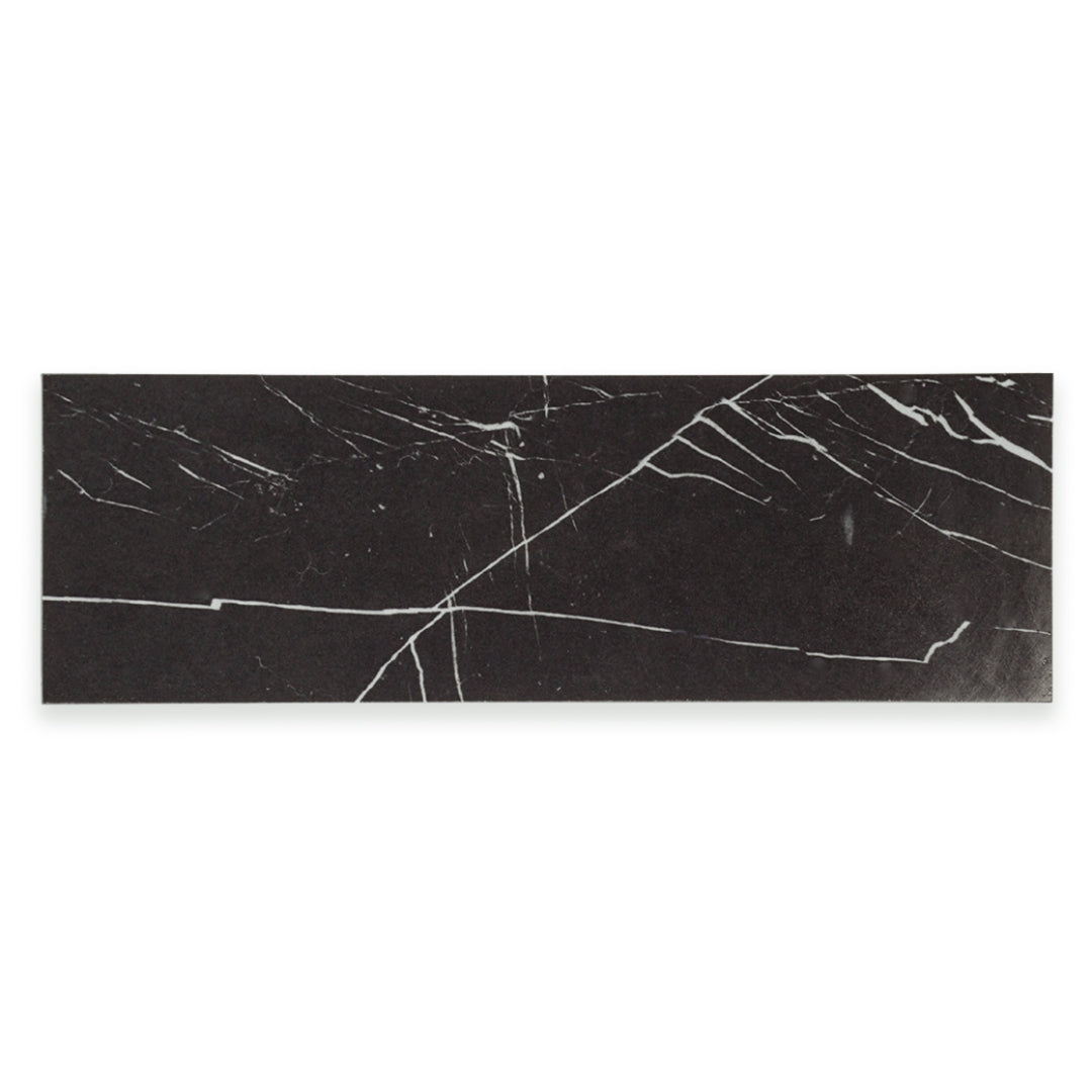 Ariel view of a single 4x12 tile in polished glossy black marble look porcelain with white veining. 