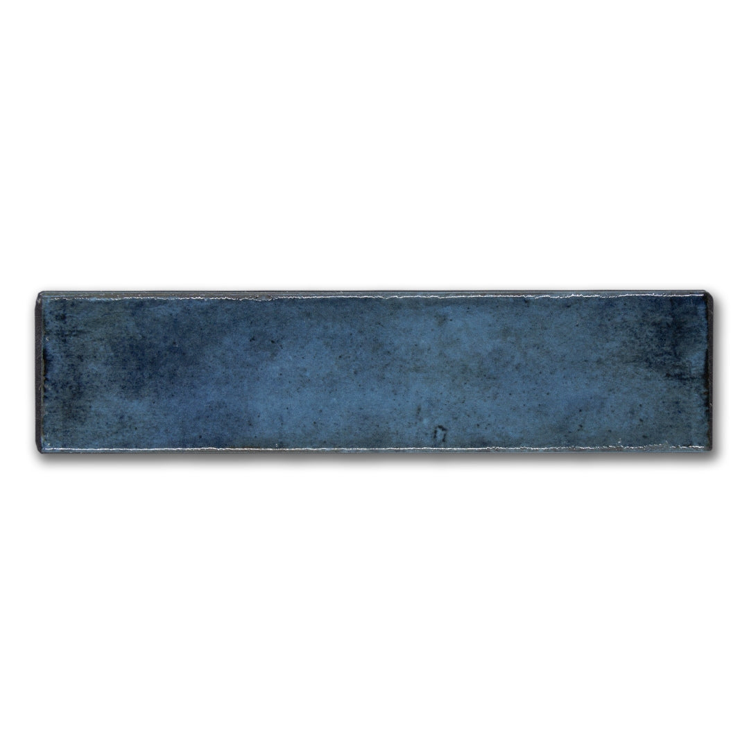 A single 2.5x8 blue matisse glossy tile with a handmade hand painted look
