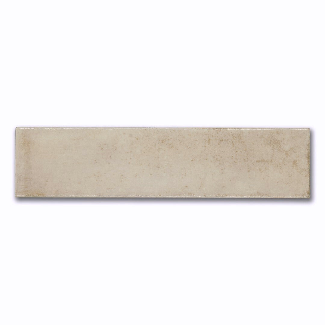 A creamy beige glossy 2.5x8 subway tile with a handmade look. 