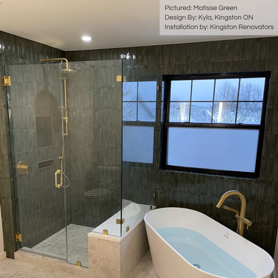 A glamerous washroom with matisse green glossy handmade look tiles on  the bathroom and shower walls. 