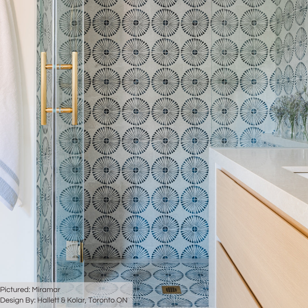 A beautiful shower dressed in Miramar 8x8 blue and grey burst pattern tiles. The walls and shower floors look like wallpaper but they are tile! 