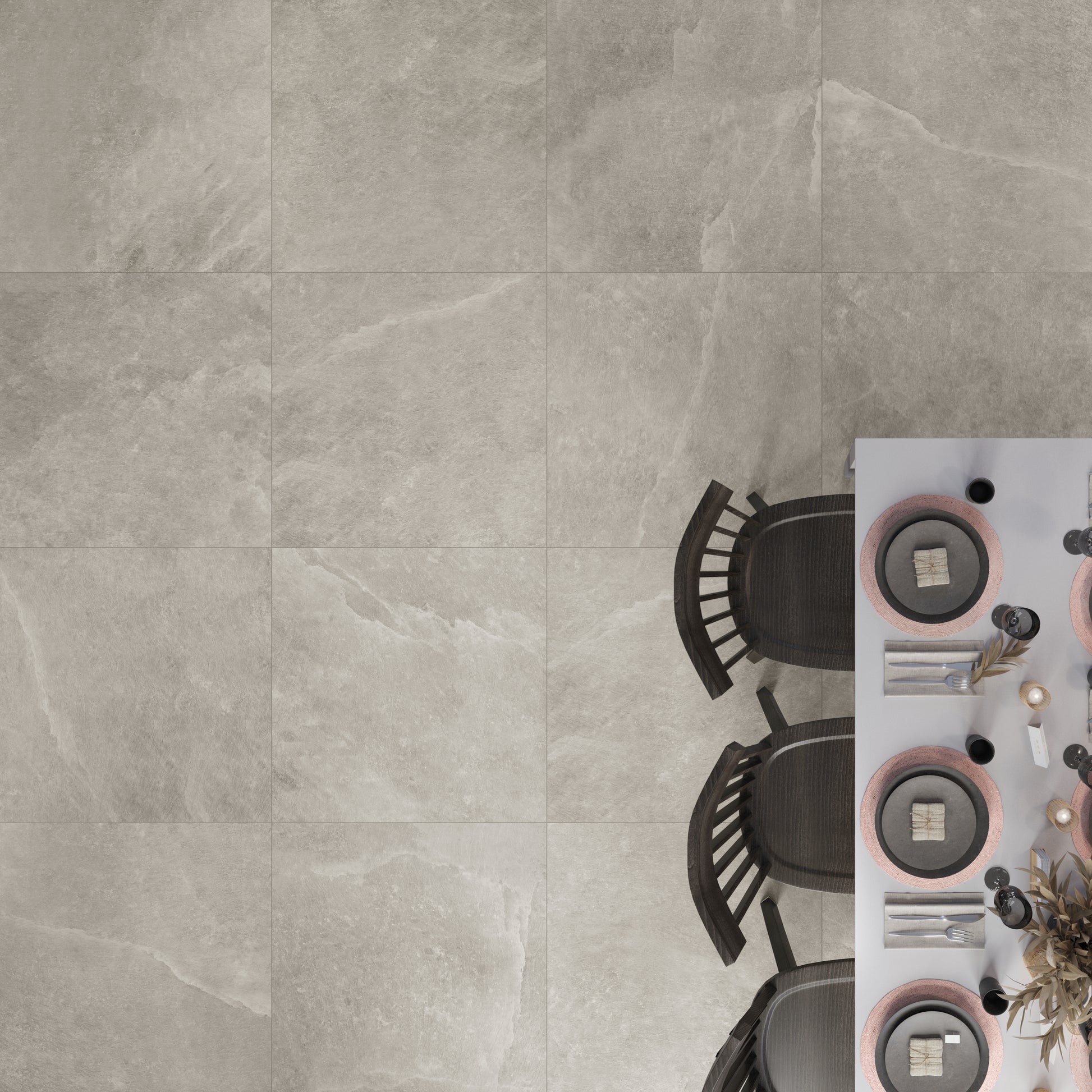 Ariel view of saltstone taupe porcelain stone look tiles used on a dining room floor. There is white veining and some beige shades throughout the tiles. 