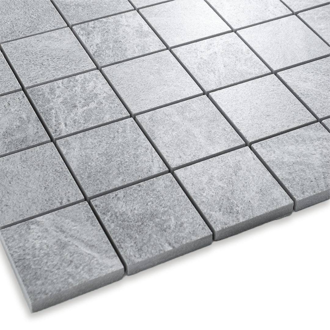 Angled close up of a light cement grey 2x2 stone look mosaic tile sheet