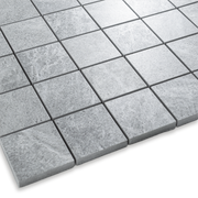 Angled close up of a light cement grey 2x2 stone look mosaic tile sheet