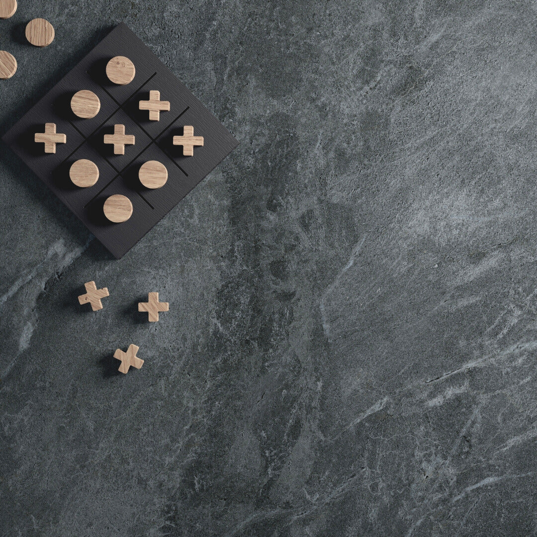 A surface application of a large dark grey stone look tile with dark and light pattern veining. 