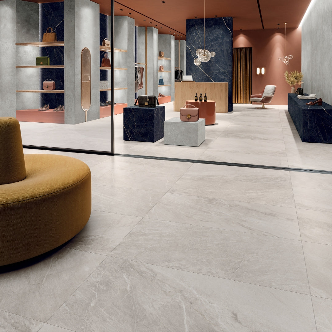 A modern shopping commercial space with large snow white stone look tile floors.