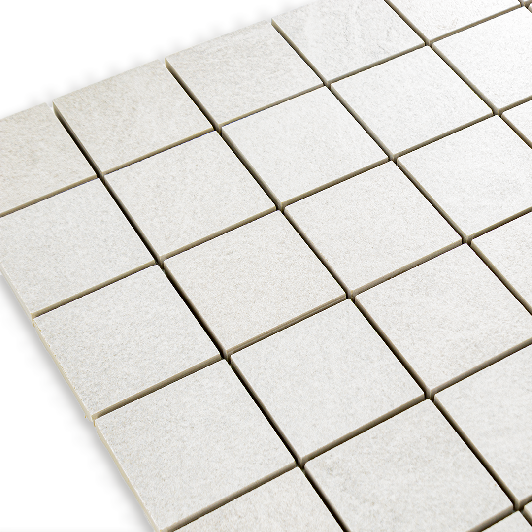 Angled close up of a cement white 2x2 stone look mosaic tile sheet