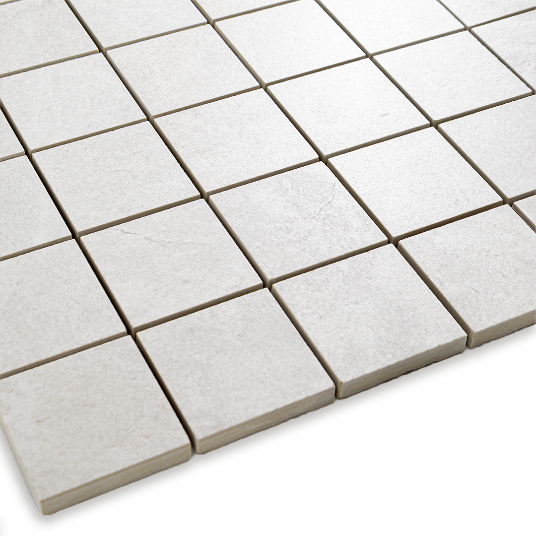 Angled close up of a cement white 2x2 stone look mosaic tile sheet