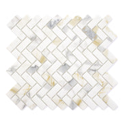 Ariel view of a single sheet of herringbone mosaic tile and the tiles are white and have a gold and grey marble veining pattern. 