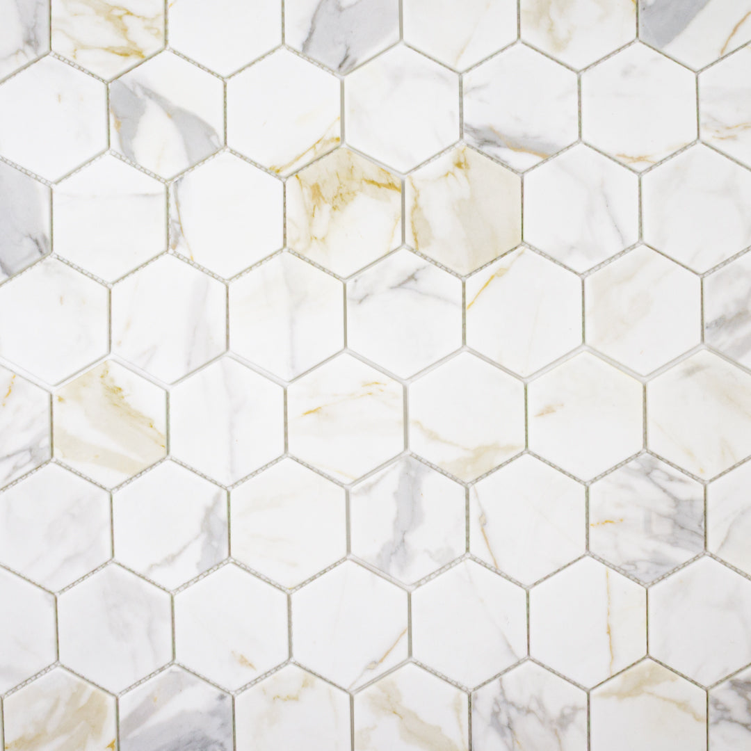 Ariel view of white and grey and golden veining marble look porcelain 3 inch hexagon mosaic tiles.