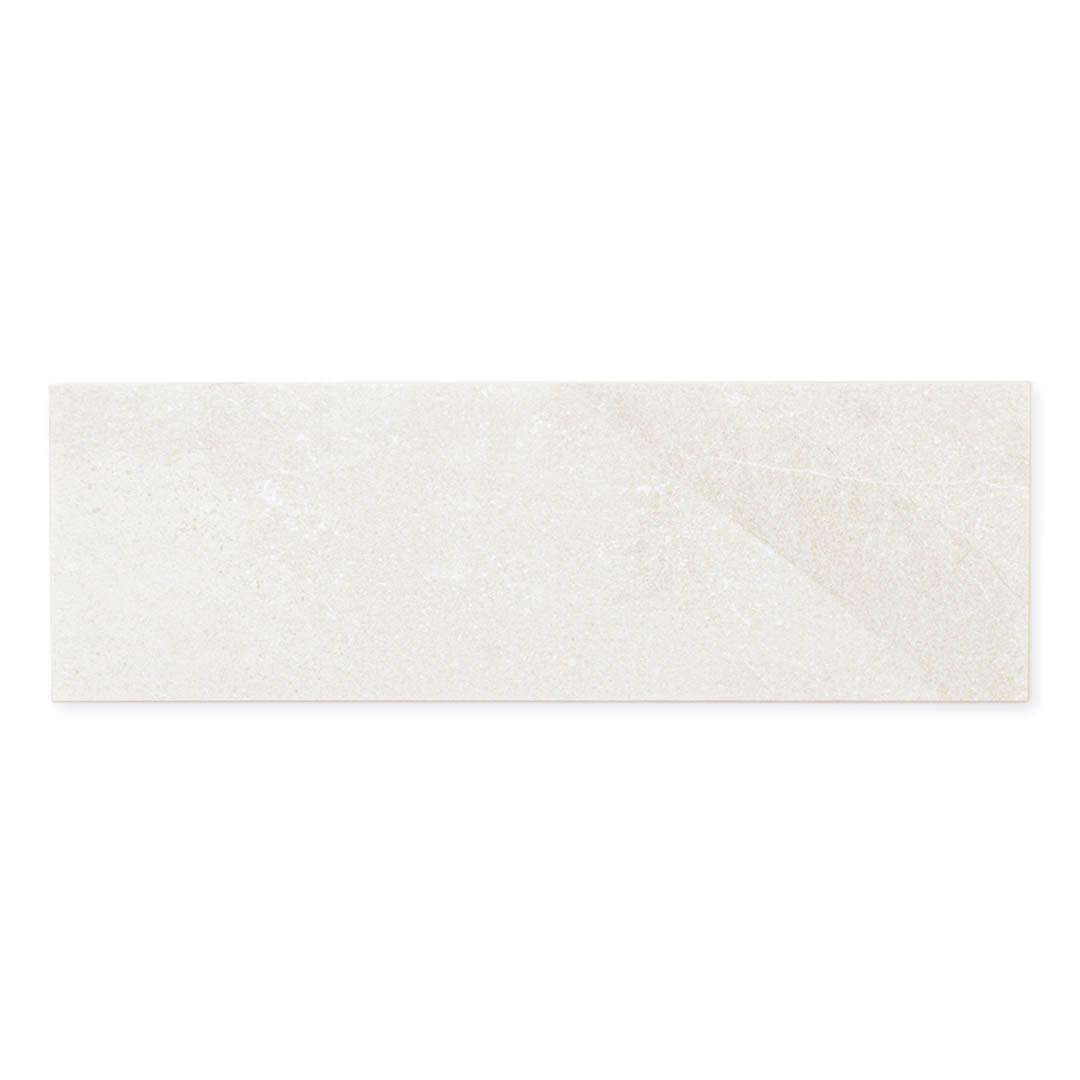 A single 4x12 light grey coloured limestone look tile with subtle veining pattern