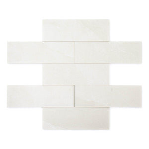 limestone look 4x12 matte tile in a light grey laid out in a brick pattern to show the pattern and variance.