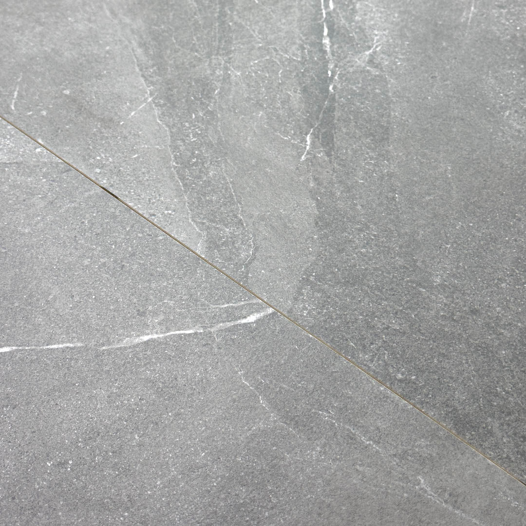 Close up of two tiles edge to edge to highlight the colour and veining of the 24x24 square stone dark grey tile stonehaven
