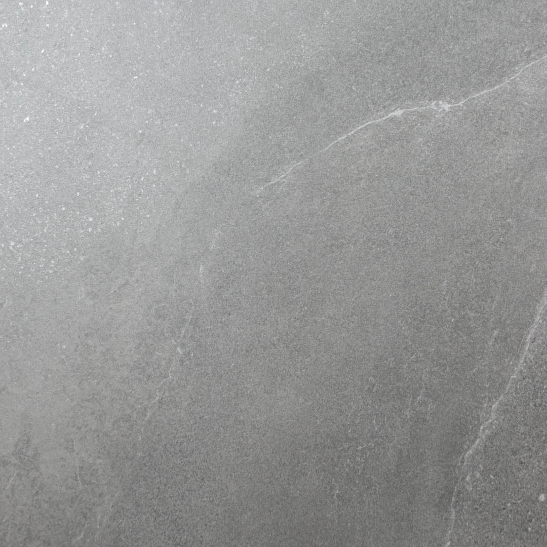 Close up of a 24x48 dark grey stone look tile with light thin delicate limestone look veining. 