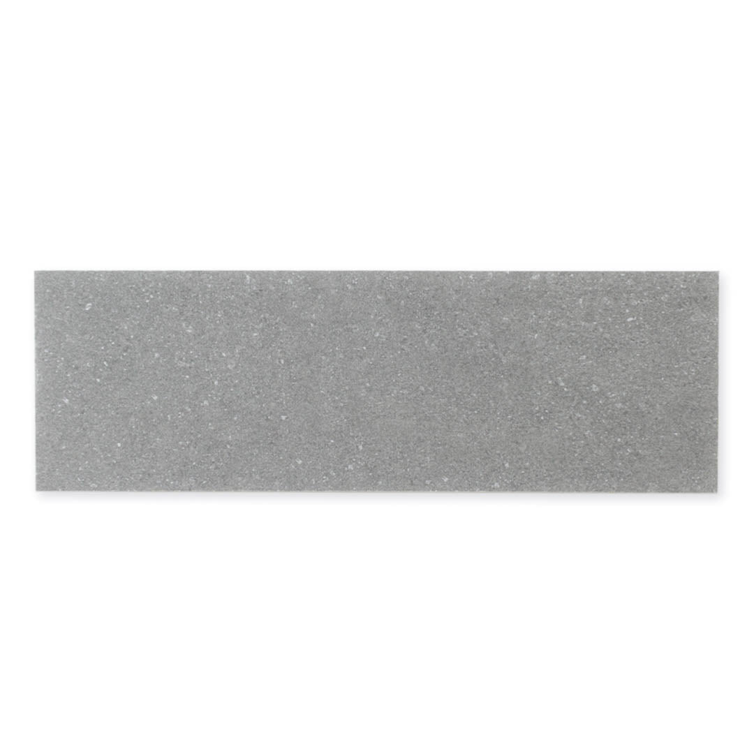 A single 4x12 dark grey coloured limestone look tile with subtle veining pattern