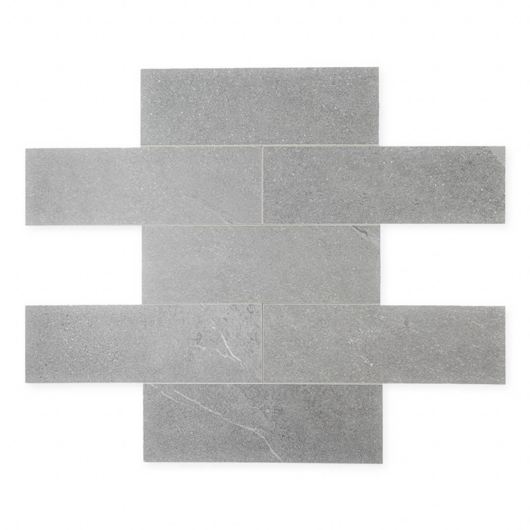 limestone look 4x12 matte tile in a dark grey laid out in a brick pattern to show the pattern and variance.