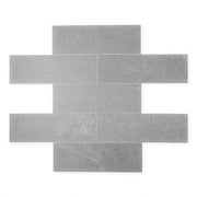 limestone look 4x12 matte tile in a dark grey laid out in a brick pattern to show the pattern and variance.