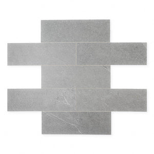 limestone look 4x12 matte tile in a dark grey laid out in a brick pattern to show the pattern and variance.