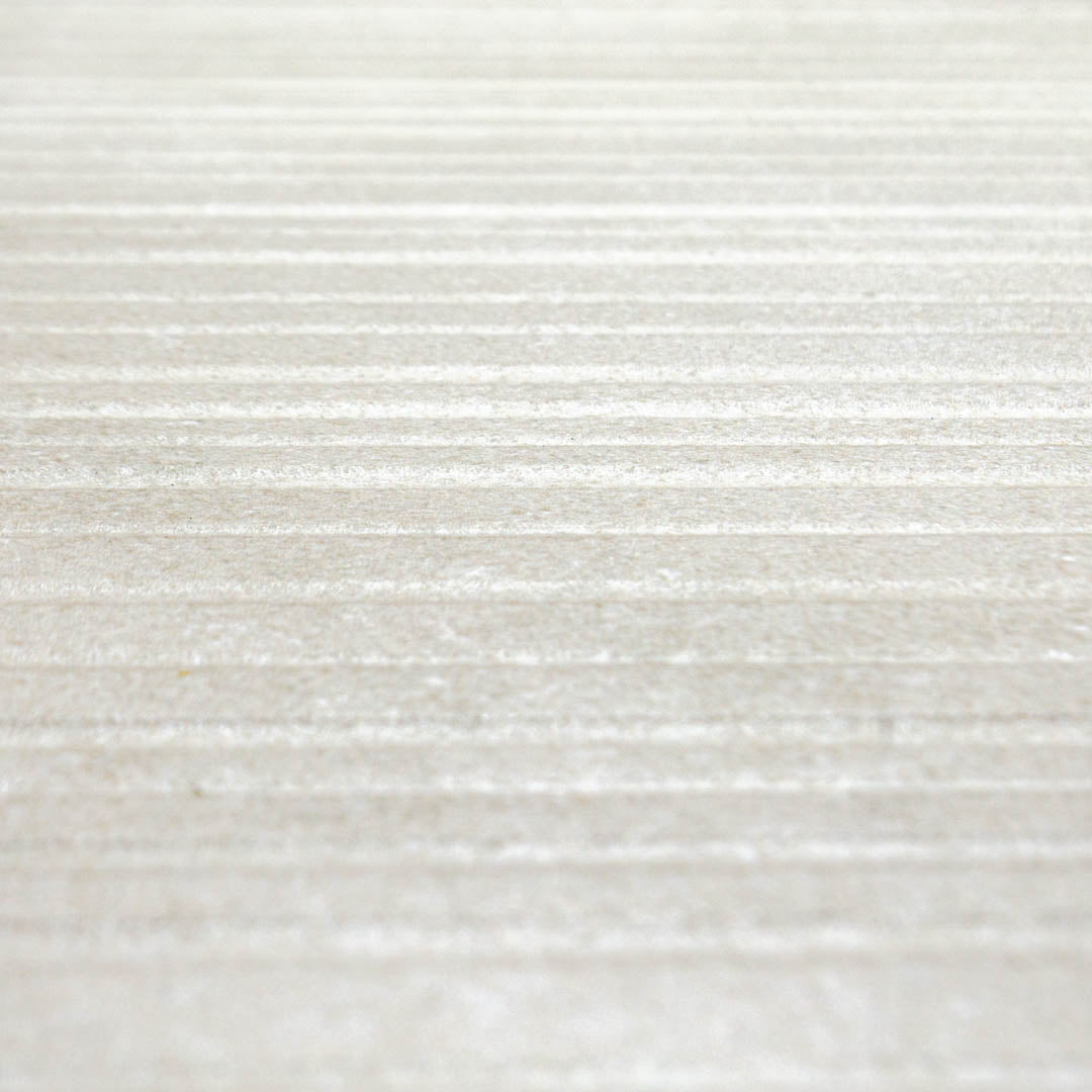 A close up of the 24x48 limestone look ivory light stone tiles to highlight both the veining pattern as well as the three dimensional line texture across the width surface of the tile. 