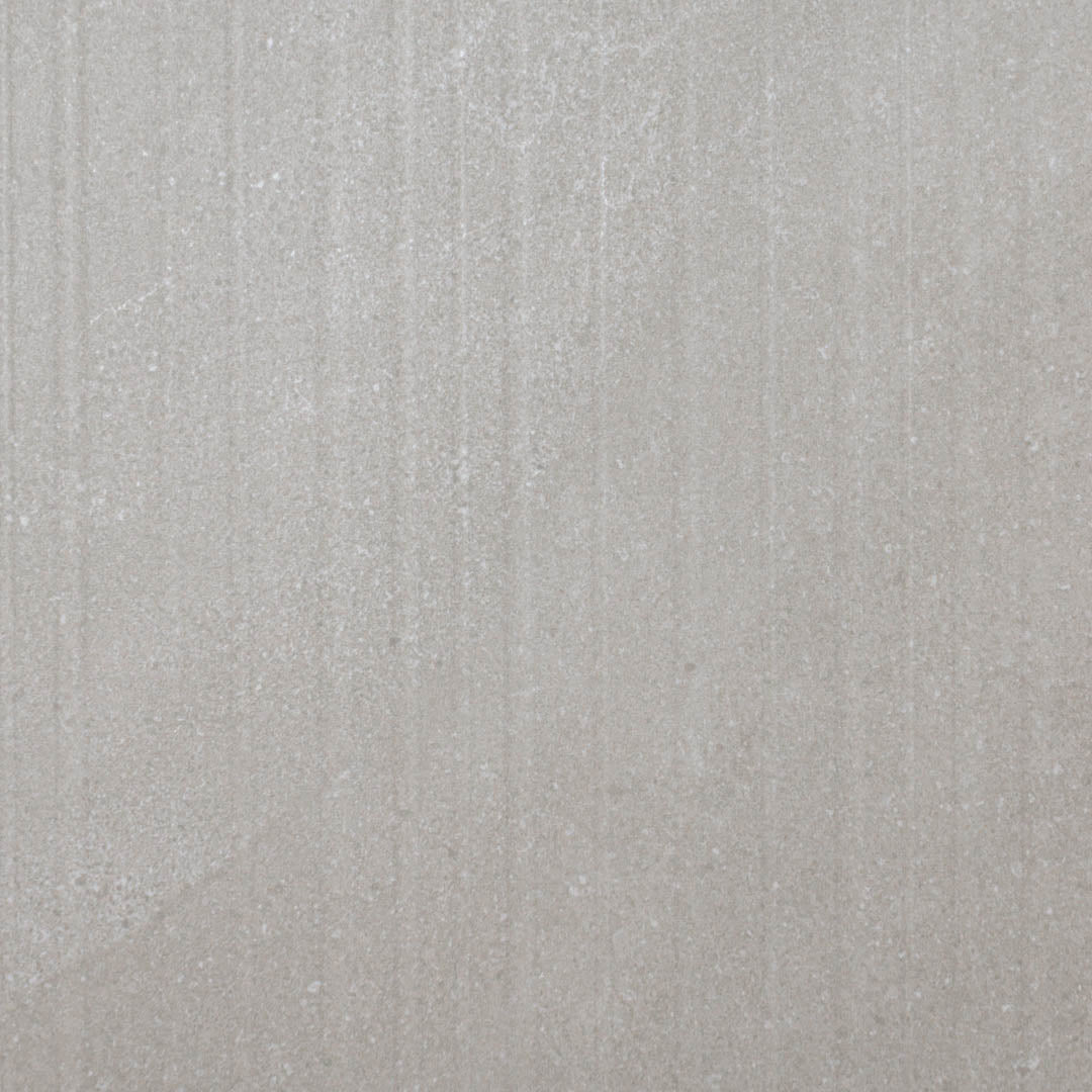 A close up of the limestone look taupe warm grey tiles with structure pattern highlighting the depth and texture of these grooves. 