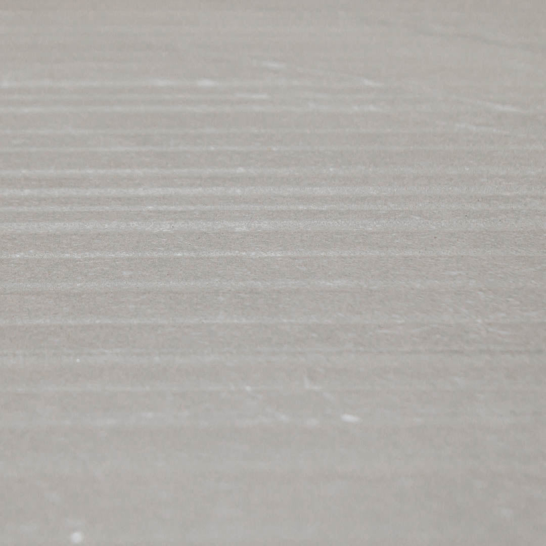 A close up of the 24x48 limestone look taupe warm grey tiles to highlight both the veining pattern as well as the three dimensional line texture across the width surface of the tile. 