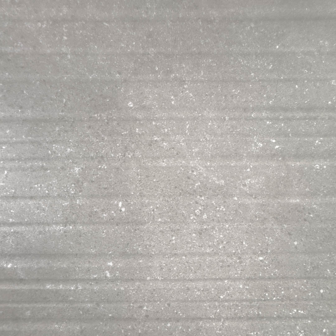 A close up of the 24x48 limestone look taupe warm grey tiles to highlight both the veining pattern as well as the three dimensional line texture across the width surface of the tile. 