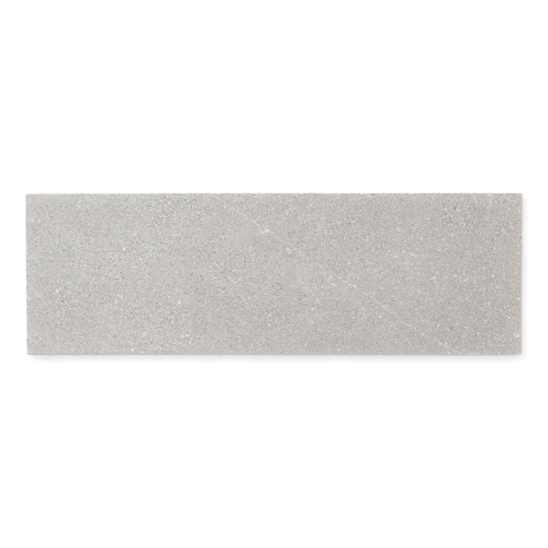 A single 4x12 taupe coloured limestone look tile with subtle veining pattern