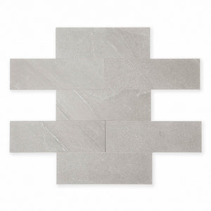 limestone look 4x12 matte tile in taupe laid out in a brick pattern to show the pattern and variance.