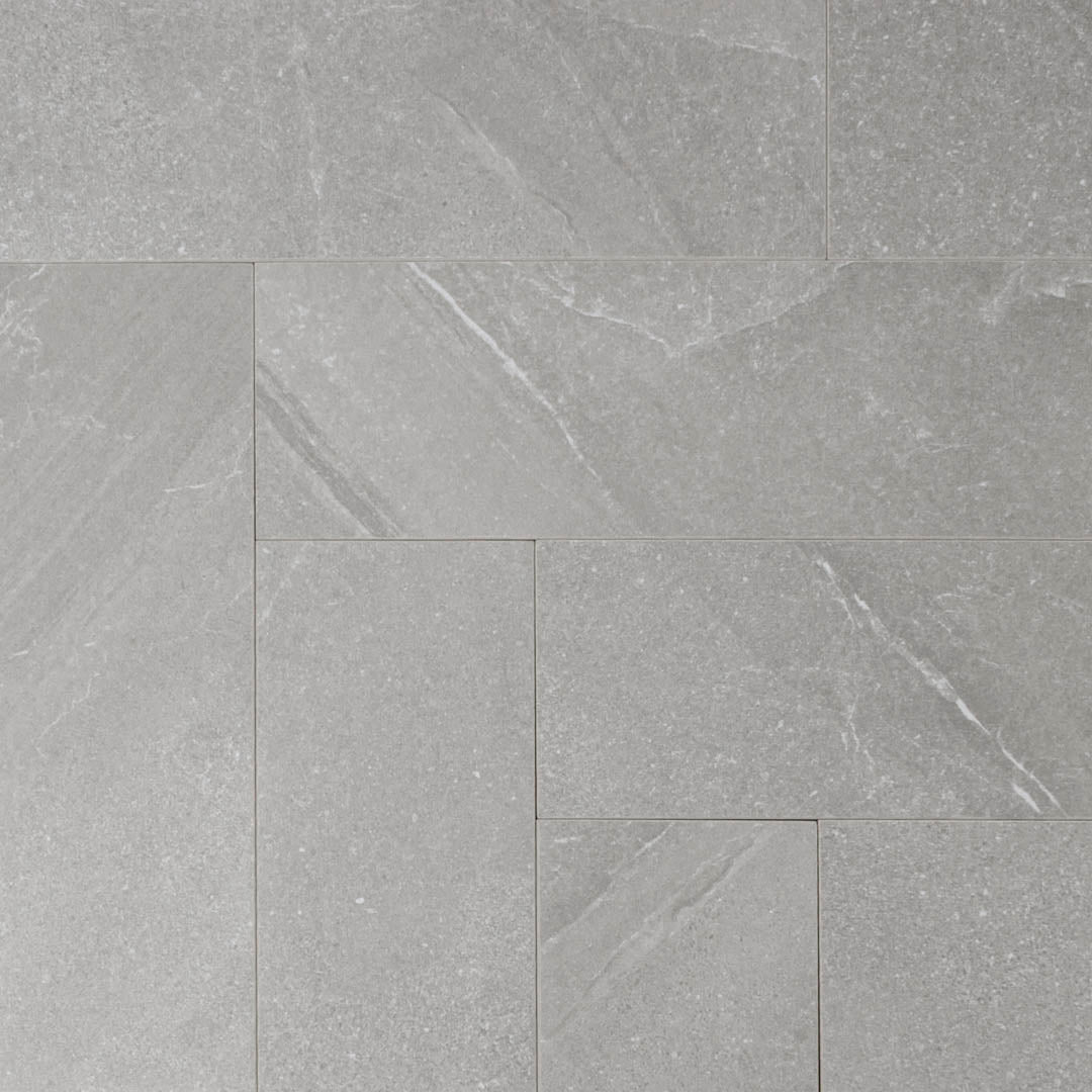 limestone look 4x12 matte tile in taupe laid out in a brick pattern to show the pattern and variance.