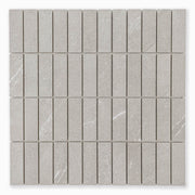 Stacked 1x3 chip mosaic sheet of tile that looks like limestone in a taupe shade with light veining pattern