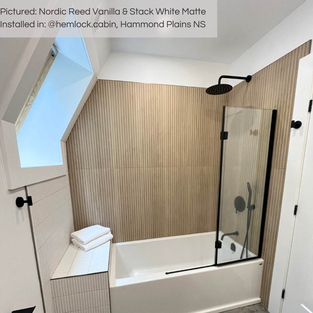 A modern shower with Nordic Reed Vanilla wood look tiles on the walls and Stack White matte kitkat tiles on the face and back rest of the shower bench. 