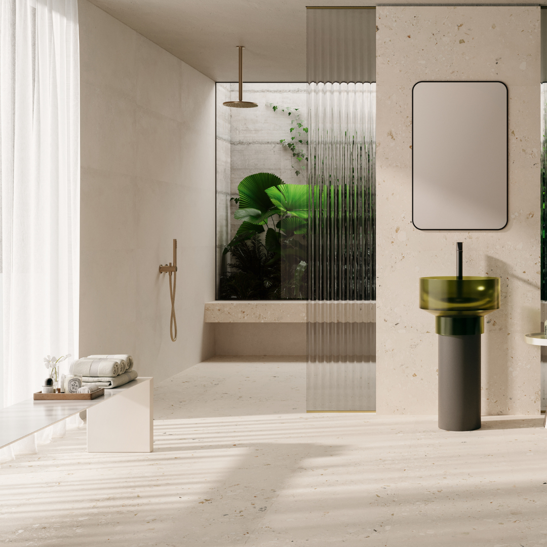 An ultra modern luxury bathroom with white, gold, green and glass finishes. the walls and floors are tiled in Oasis Light cement terrazzo look tiles in a matte 36x36 format. 