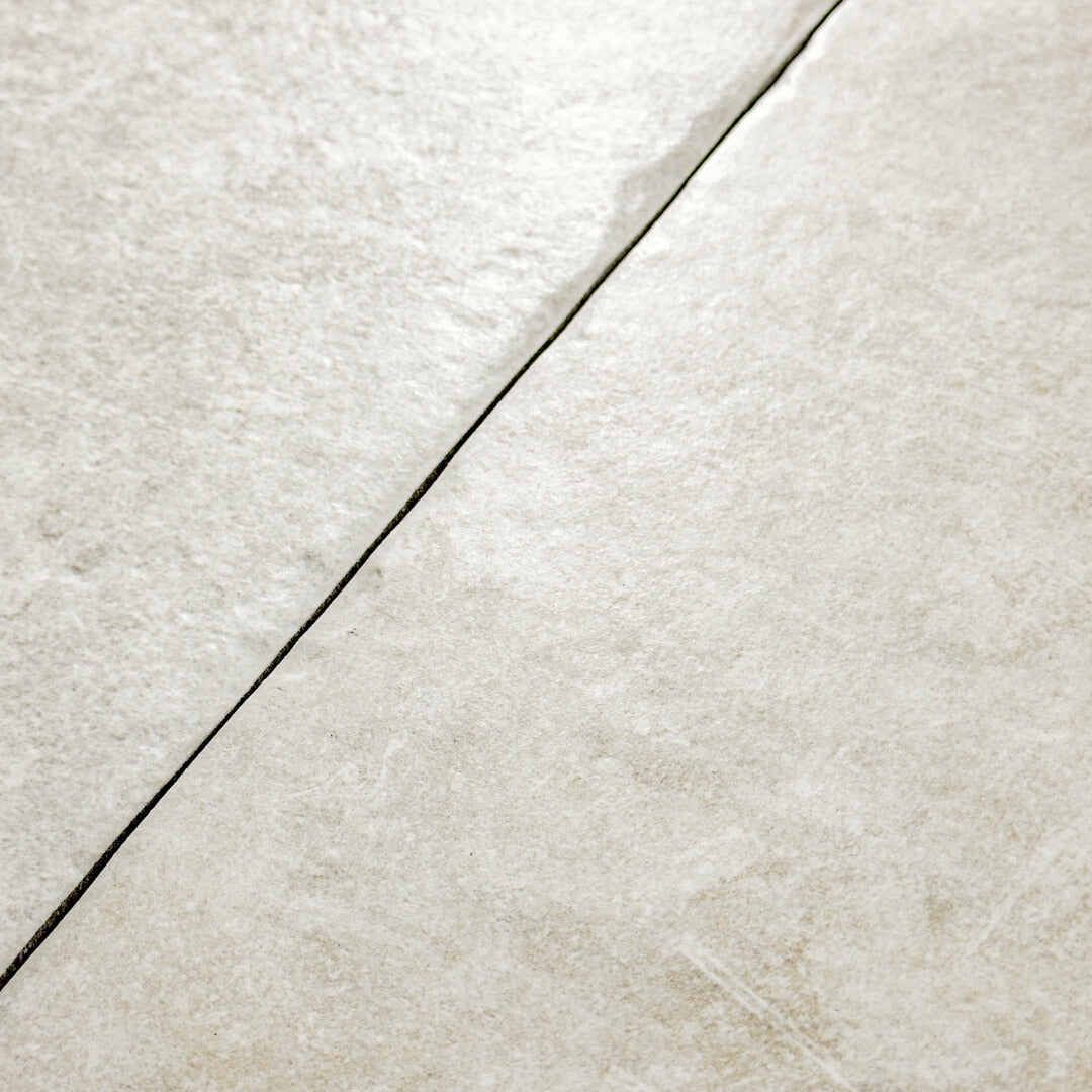 Close up, detailed view of the light grey tumbled edges of the textured modular multi-format tile Cottage Chalk.
