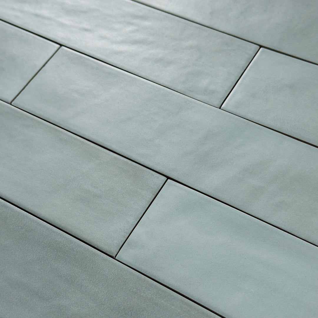 Close up detailed view of a green 2x9 matte subway tile with subtle texture. 