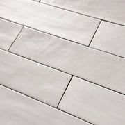 Close up detailed view of a 2x9 matte subway tile in a light grey shade with subtle texture.
