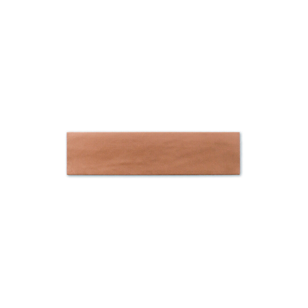 Single tile photo of a a terracotta coloured 2x9 matte subway tile. 