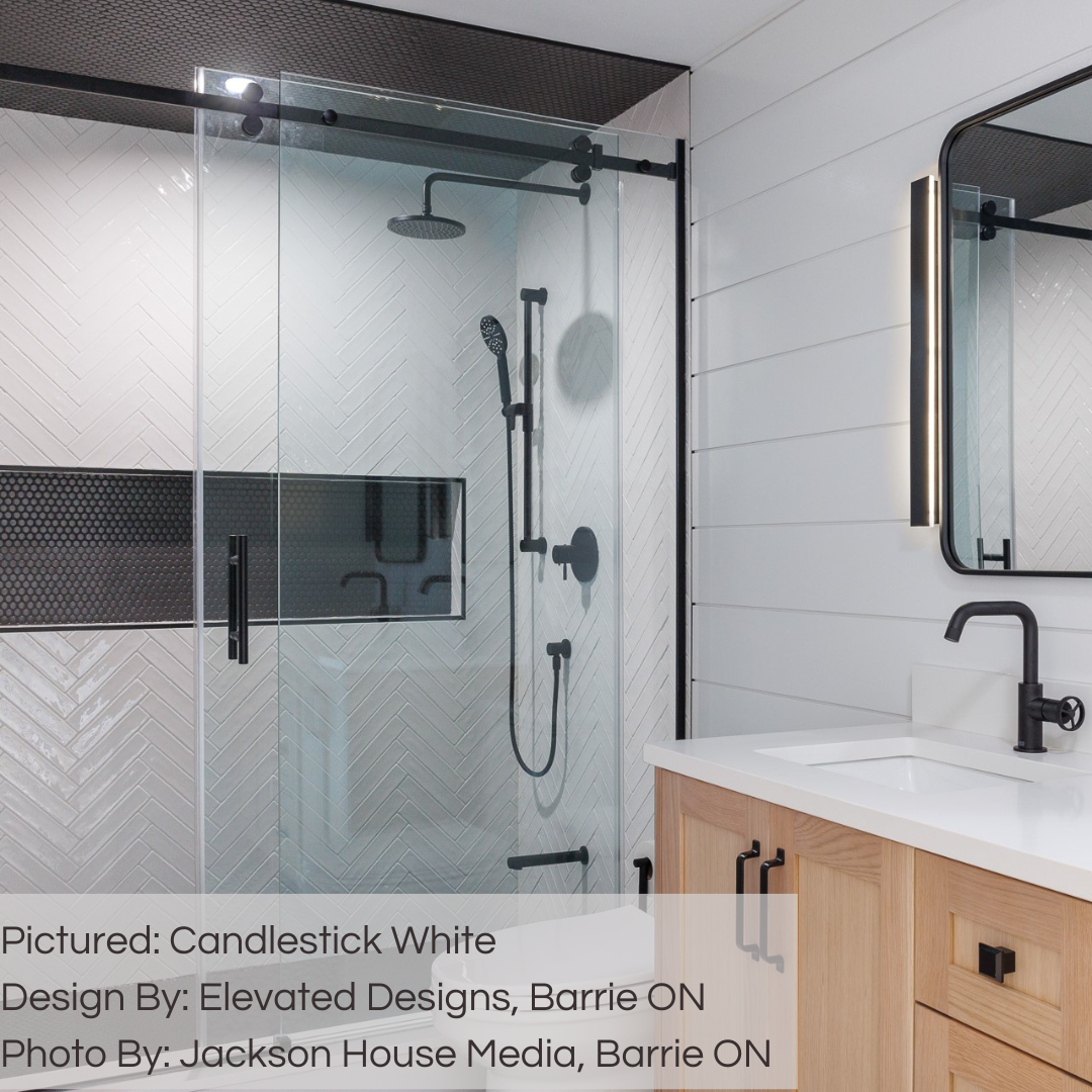 A modern black and white bathroom. the shower has 2x10 candlestick white glossy tiles on the walls laid out in a chevron pattern. the back wall of the niche and shower ceiling has a modern black penny tile to match all the trim work in the bathroom. 