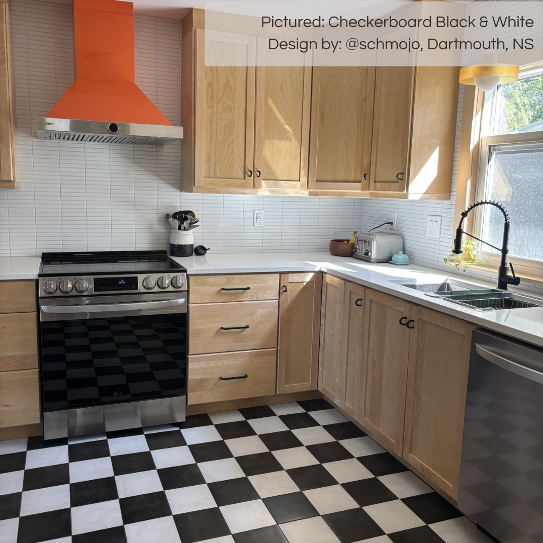 A funky and modern kitchen with a bright orange range hood that perfectly matches the bold floors. the floors are tiled with a black and white 8x8 checkerboard tile from tilesinspired. the cabinets are light wood, and the backsplash is a white mosaic. 