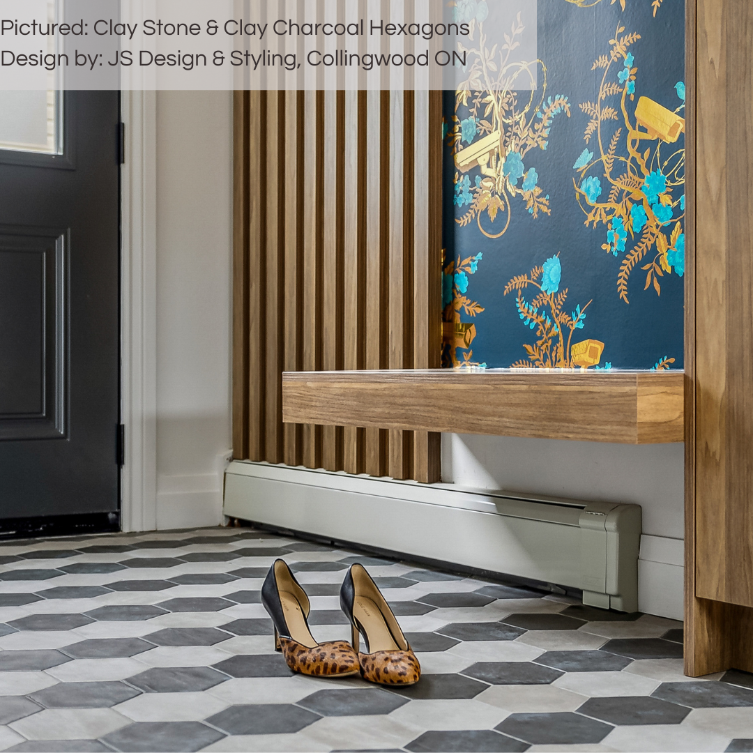 A close of an eclectic maximalist entryway with wood accents and bold wallpaper. he floor tile is the main focus as it is a bold stripe pattern using 6" stone look hexagon tiles in charcoal and grey