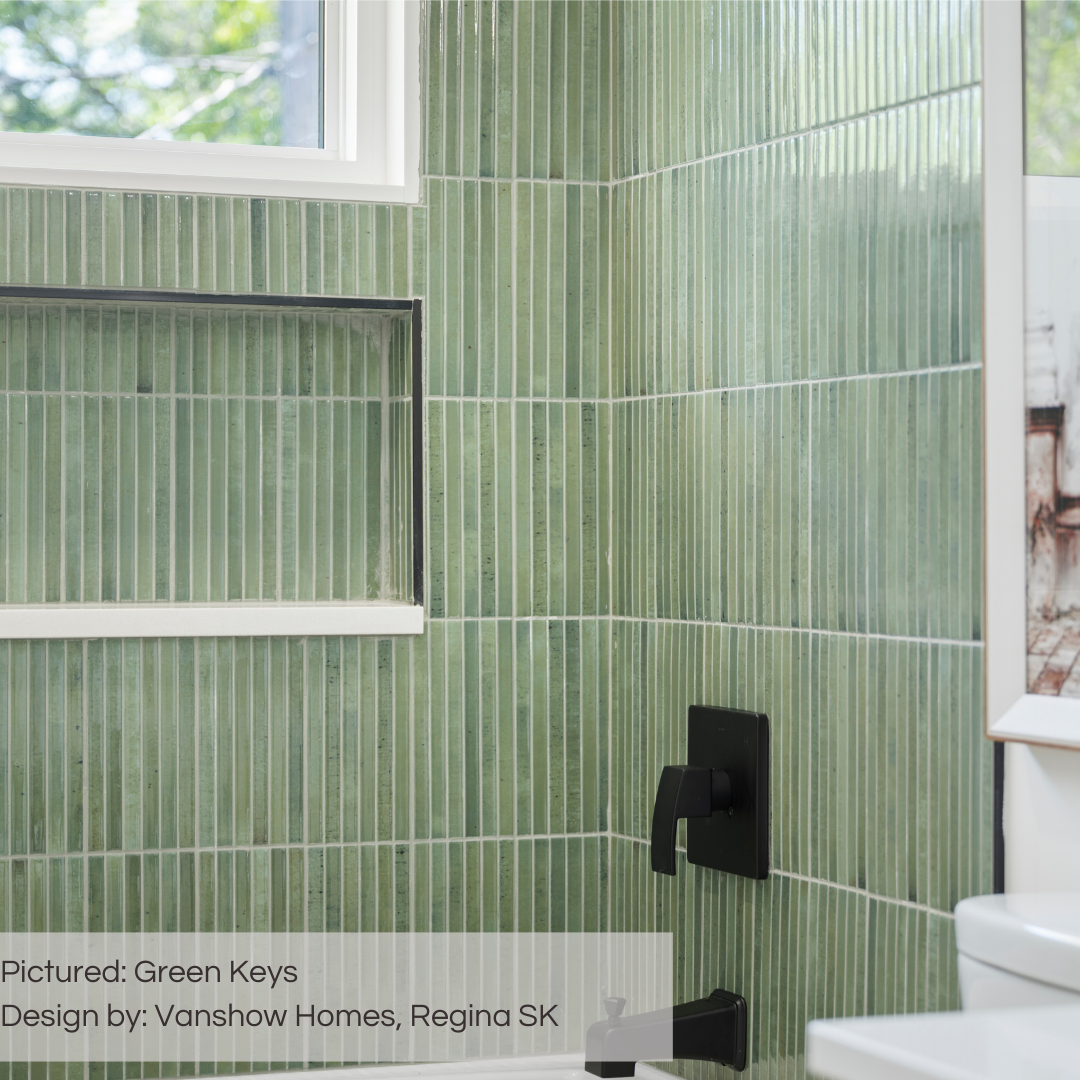 A close up of a bathroom and shower tub surround. There is a window and a niche for storage. The tiled walls are green keys kitkat fluted tiles with light grout to maximize the visual texture! 