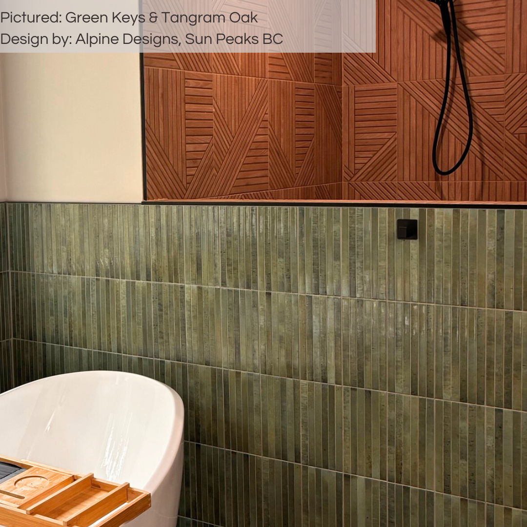 A spa like bathroom with a soaker tub, the half wall tub surround is tiled with green keys 5x10 fluted kitkat tiles. beyond the half wall is a walk in shower tiled with tangram oak patterned wood look tiles. 